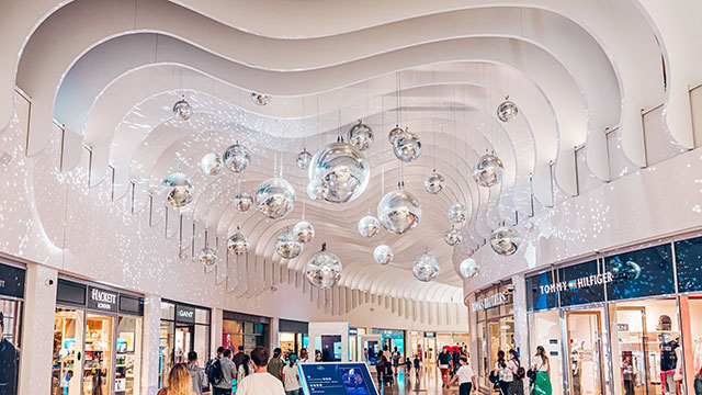 The interior of the Icon Outlet at The O2, filled with shops and people
