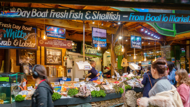 People shop for fresh fish at Borough Market in London.