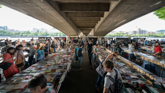 People browsing through stalls of books at the Southbank Centre Book Market.
