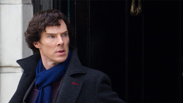 Benedict Cumberbatch as Sherlock Holmes shown exiting 221b Baker Street.