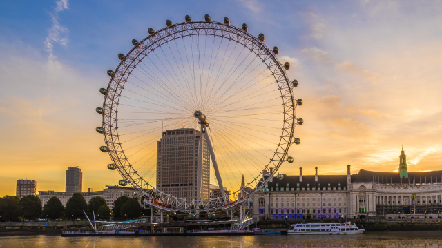 View of the London Eye on the river Thames at sunset.