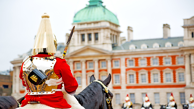 View of the back of a horseguard reviewing the mounted regiment on Horse Guard during Trooping the Colours.