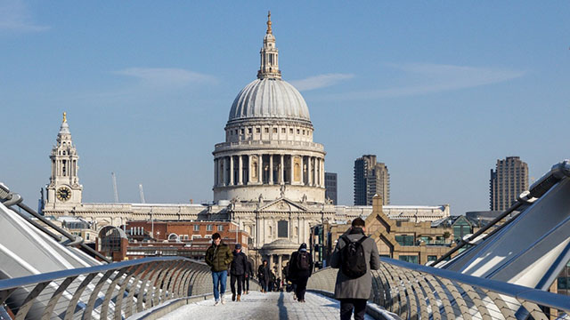 St Paul's Cathedral and the Millennium Bridge in the snow on a sunny day. 