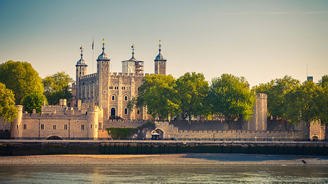 Tower of London at dusk, on a clear day, taken from across the Thames.