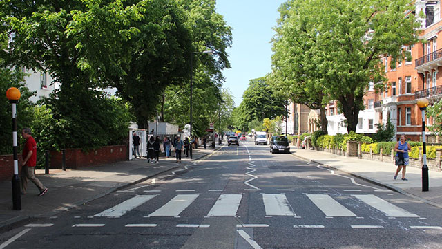 The famous pedestrian crossing from the Beatles' iconic album cover near Abbey Road Studios on a sunny day