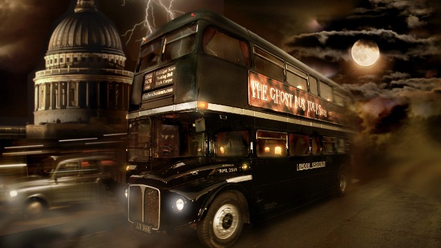 The black Routemaster, the Ghost Bus Tours, driving across London by nighttime with a full moon and St Paul in the background.