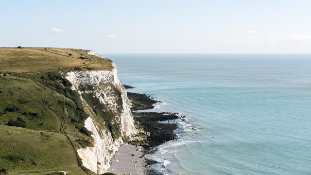 White Cliffs of Dover plunging into the blue sea on a clear day.