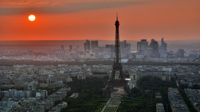 Paris skyline with the Eiffel Tower at sunset.