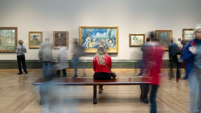 A woman looks at a painting at the National Gallery in London.