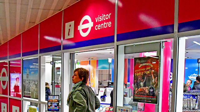 Person standing in front of a Transport for London Visitor Information Centre