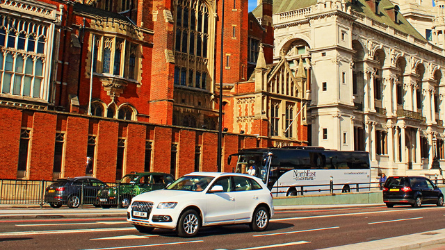 A coach and cars drive in the Congestion Charge Zone in central London