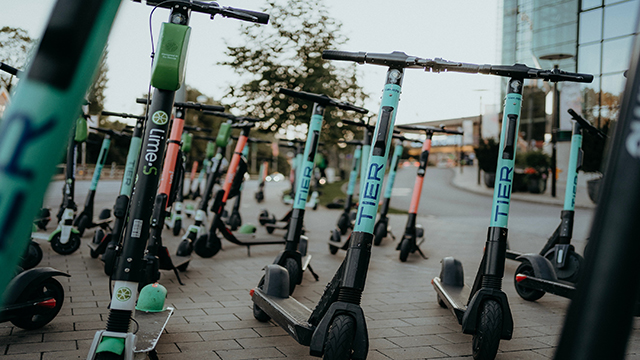 E-scooters parked on the pavement ready to be used.