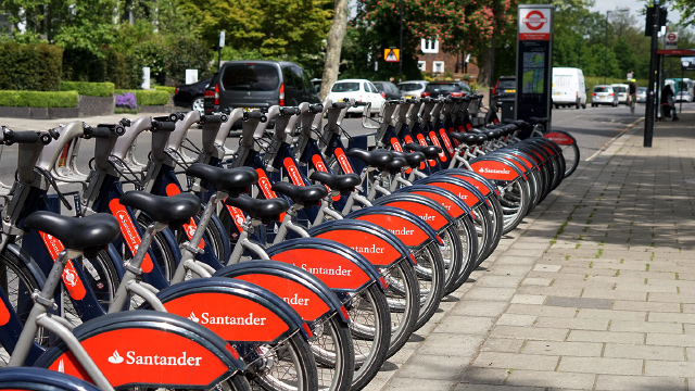 A row of docked Santander cycles in London on a sunny day