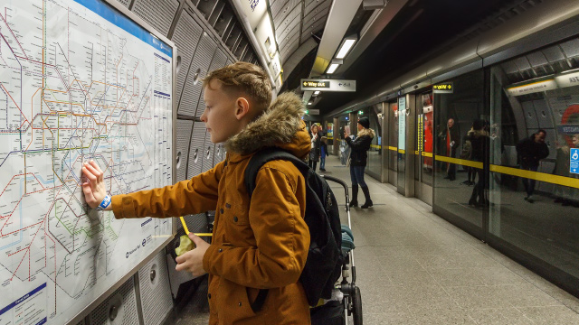Young boy looks at a map of the London Underground in a Tube station