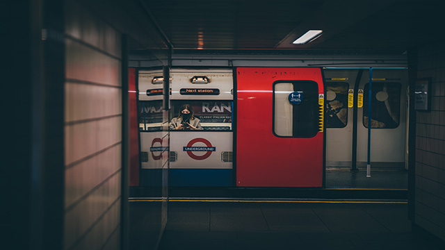 Une femme est assise dans le métro londonien, le Tube.