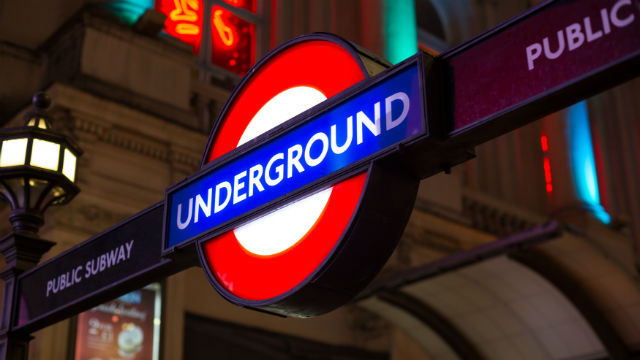 Illuminated London Underground roundel at night at a Tube station