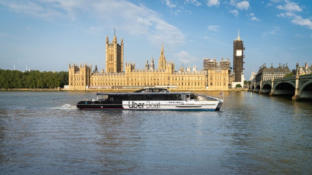 The Jupiter clipper operated by Uber Boat by Thames Clippers sails past the Houses of Parliament. 