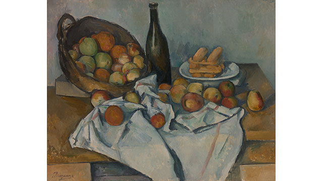 Paul Cezanne (1839-1906) The Basket of Apples, 1893. Image courtesy of the The Art Institute of Chicago, Helen Birch Bartlett Memorial Collection. A still life painting of a basket of green, red, orange and yellow apples on a table covered in a table cloth and more apples with a bottle of wine and a plate of food behind