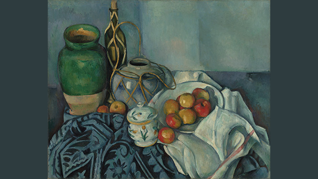 A still life painting of a basket of red and yellow apples on a table covered in a table cloth with a bottle of wine behind