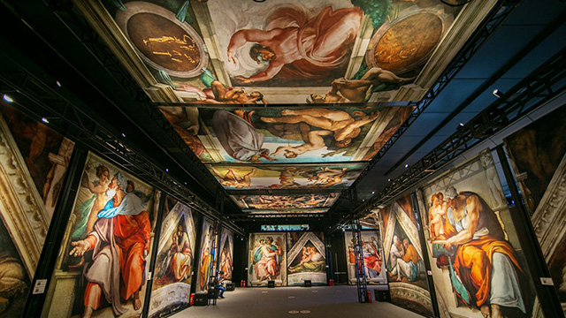 Replicas of the Sistine Chapel frescoes on the walls and ceiling, as part of the indoor exhibition.