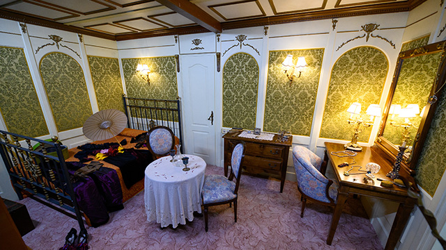 The interior of the Titanic with tables, chairs and desks.