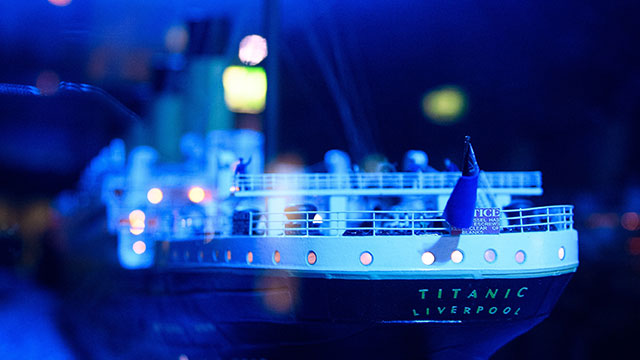 A model of the ship Titanic illuminated with blue lights