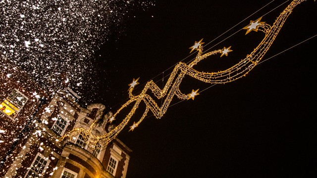 Christmas lights sparkle above Marylebone Village and fake snow falls during Christmas in London