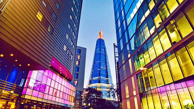 View of The Shard at night with its summit lit with a golden light. 