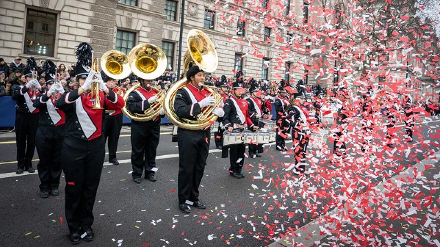 A marching band performs surrounded by confetti during the London New Years Day Parade