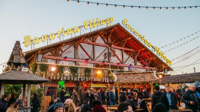 Visitors enjoy a drink and live music at the Bavarian Village at the Hyde Park winter wonderland in london.
