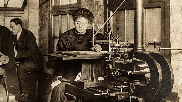 Old, black and white photograph showing a woman working on creation of banknotes.