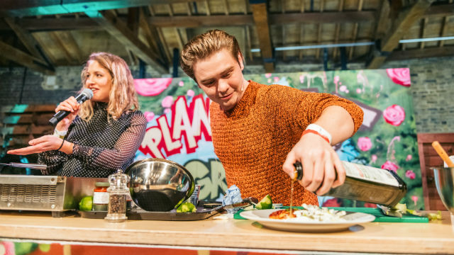 A photo of a person putting olive oil on a dish during cooking demonstrations at Taste of London.