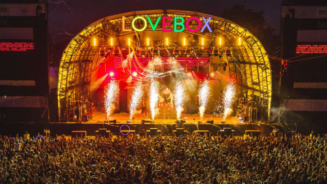 Huge crowd in front of colourful stage at Lovebox festival.