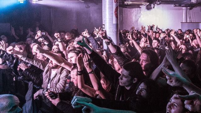 Crowd of people with raised arms listening to a live music gig at The Underworld in London