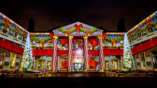 Festive light projections are projected on Kenwood House in London at night.