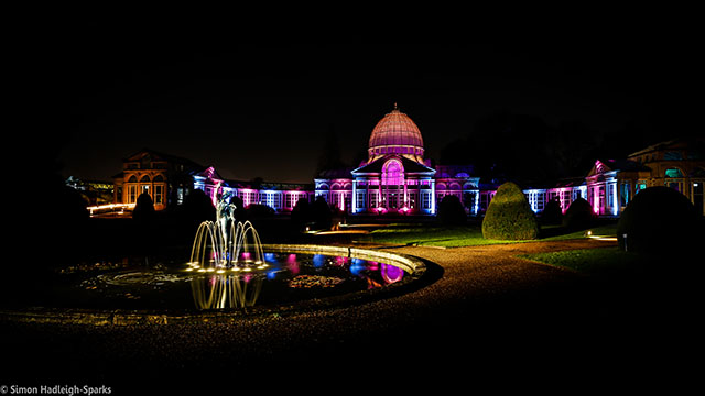 Syon House and its gardens are illuminated by neon lights of various colours at night in London.