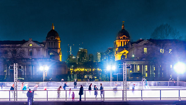 People skating at the Queen's House ice rink in Greenwich at night