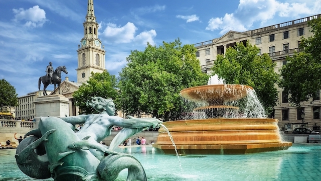Fountains in Trafalgar Square in London on a sunny day.