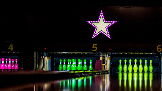 Bowling pins lit up in neon colours at Hollywood Bowl in London.