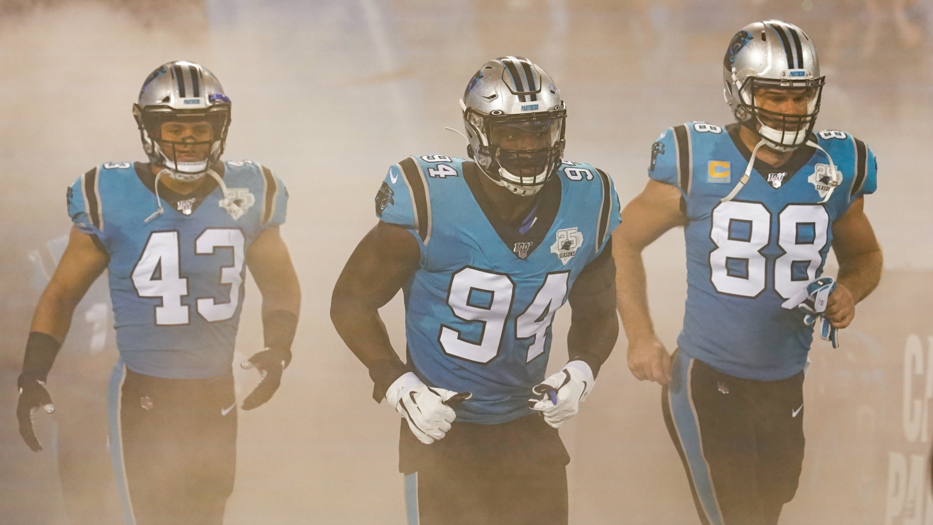 Three Carolina Panther players run onto the field. Image courtesy of NFL UK and Dave Shopland. Three Carolina Panther players run onto the field. Image courtesy of NFL UK and Dave Shopland.