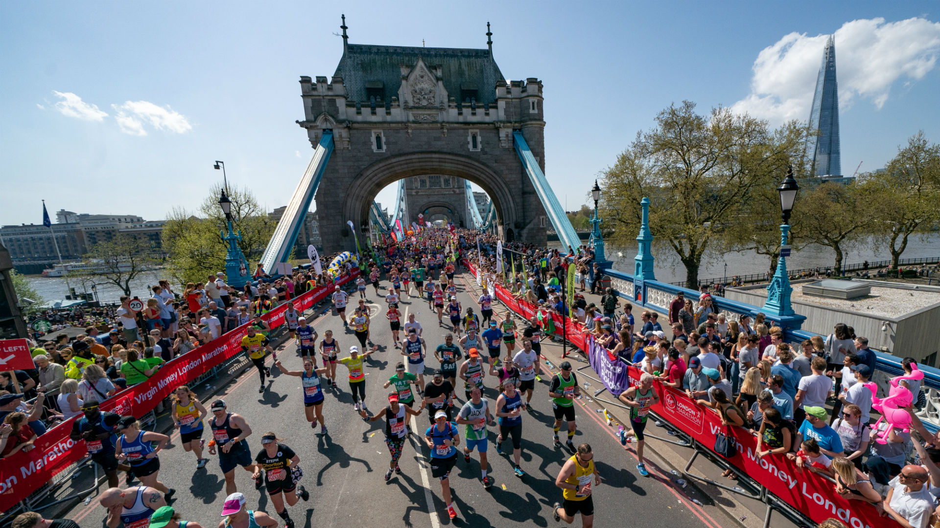 Crowds running over Tower Bridge during the Virgin Money London Marathon