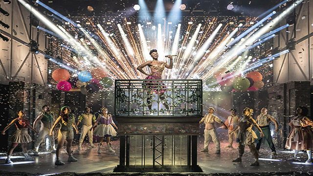 Miriam Teak Lee plays the role of Juliet in & Juliet and stands above the rest of the cast while glitter explodes in the air and neon lights are directed to the centre stage.