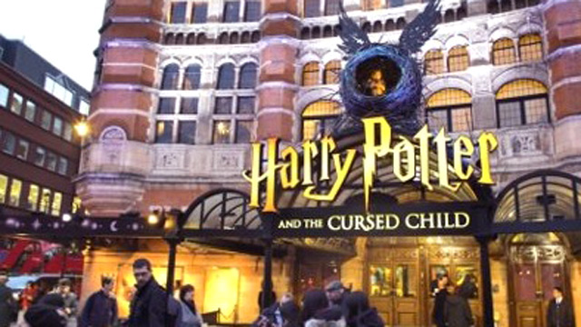 Harry Potter sign at the Palace Theatre with people queuing outside