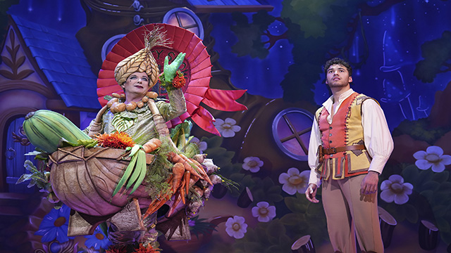 Two men stand on the stage of the London Palladium portraying Jack and the Beanstalk.