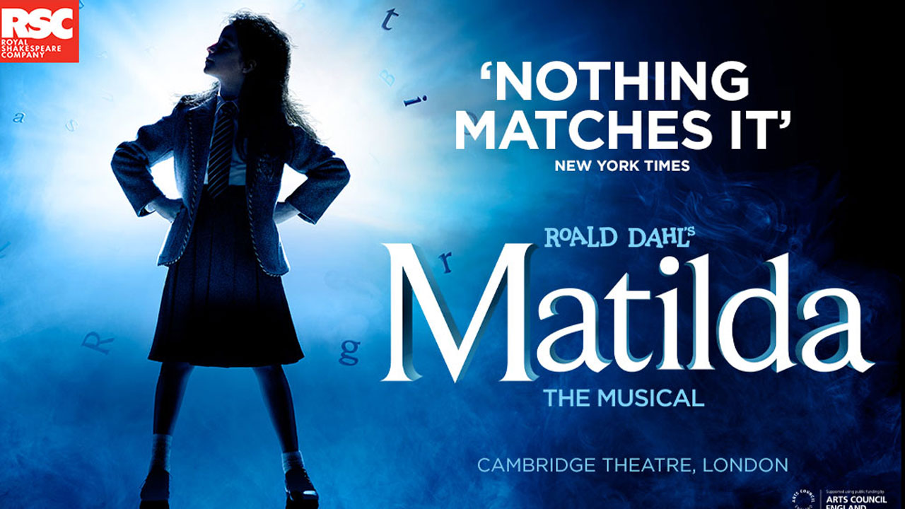 Official poster of Matilda The Musical where a young girl stands with her hands on her hips looking authoritatively at the horizon.