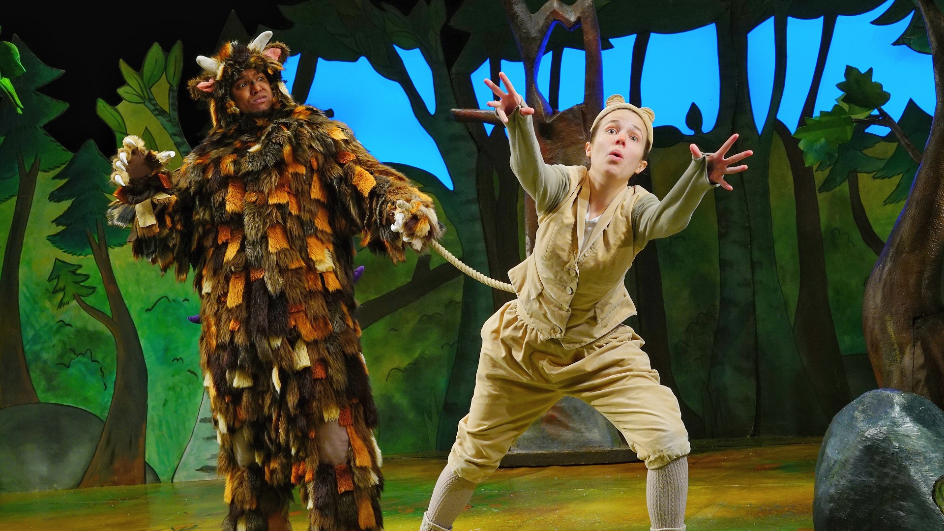 The Gruffalo grabs Mouse's tail on stage.