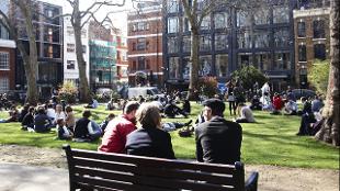 People sitting on a park bench in Hoxton Square. Image courtesy of Hoxton Square.