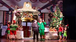 Elf the Musical at the Dominion Theatre, Buddy stands with the manager in the Father Christmas toymaking store. Image courtesy of Mark Senior.
