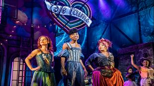 Miriam Teak Lee and fellow cast members stand on the stage of the Shaftesbury Theatre in Londonin the musical & Juliet. Image courtesy of See Tickets.