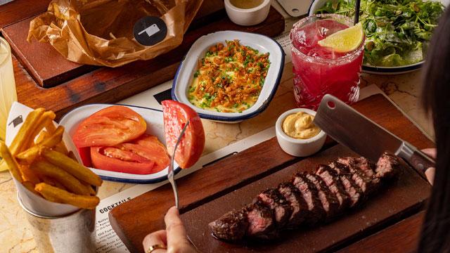 Steak and side dishes. Credit: Justin de Souza. Image courtesy of Flat Iron.